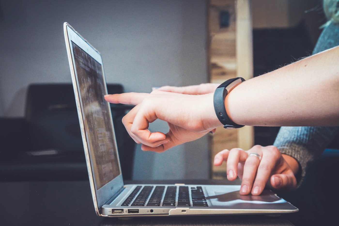 People discussing work together at a laptop
